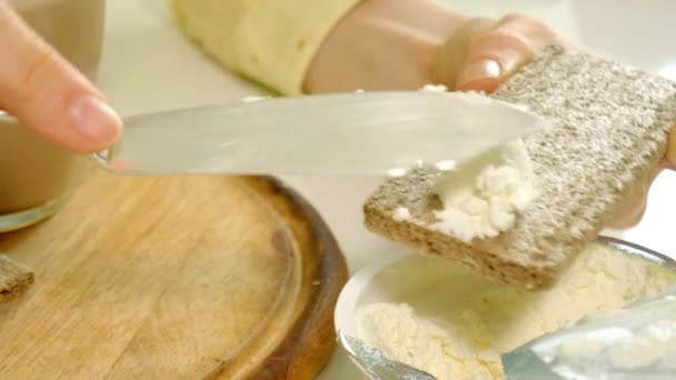 Beautiful young girl making a toast with butter in kitchen at home — Stock Video