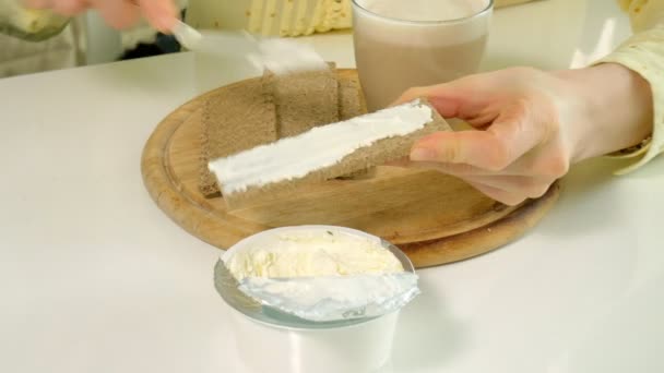 Beautiful young girl making a toast with butter in kitchen at home — Stock Video