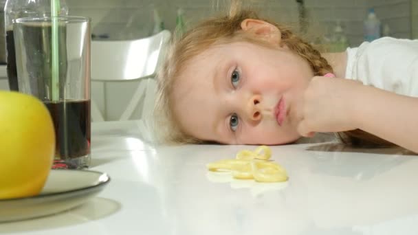 Beautiful sweet girl refuses a plate of fruit, chocolate, chips, takes a plate of snacks, chocolate, chips — Stock Video