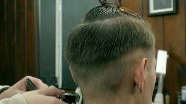 Barber zastřihne vlasy klienta s nůžkami — Stock video