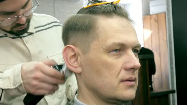 Friseur schneidet dem Kunden mit Schere die Haare — Stockvideo