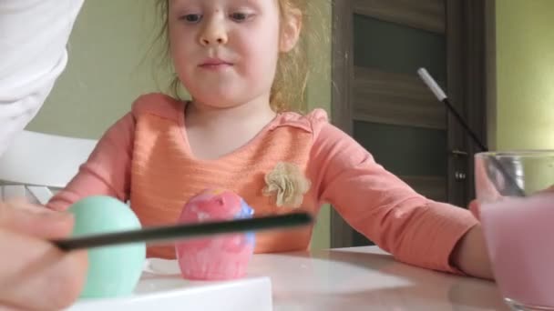 Mutter und Tochter malen Ostereier mit bunten Farben — Stockvideo