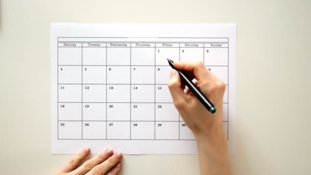 Meld u de dag in de kalender met een pen, trekken van een teek — Stockvideo