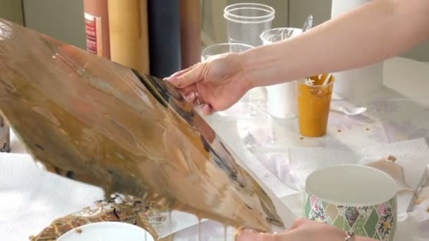 Woman draws a picture of a fluid art on canvas — Stock Video