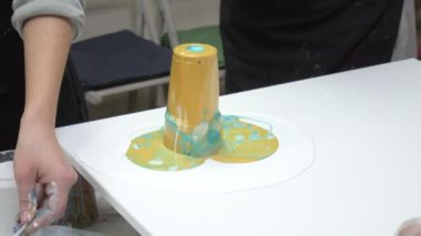 kadın bir resim sanat sıvı tuval üzerine çizer.