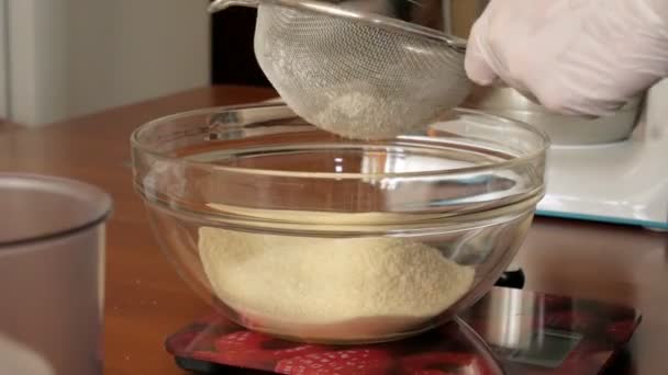 Woman preparing dough and cream for dessert macaroons in home kitchen, close-up — Stock Video