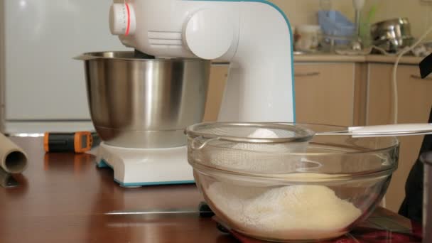 Woman preparing dough and cream for dessert macaroons in home kitchen, close-up — Stock Video