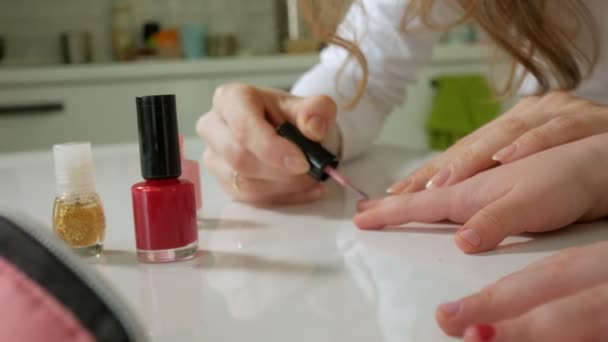 Mother and daughter having fun painting fingernails, family time concept — Stock Video