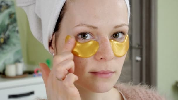 Aantrekkelijke vrouw spplying cosmetische gezichts patches thuis — Stockvideo