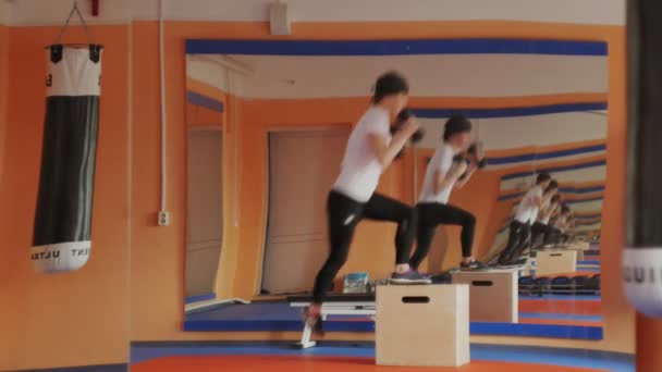 Kickboxerin trainiert im Sportstudio mit Hanteln — Stockvideo