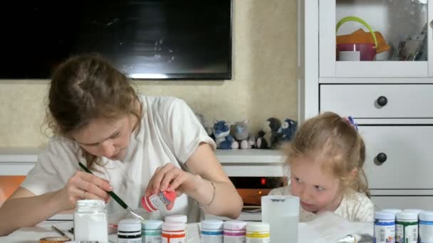 Мать и ребенок рисуют цветными пальцами. Игры с детьми влияют на развитие детей раннего возраста . — стоковое видео