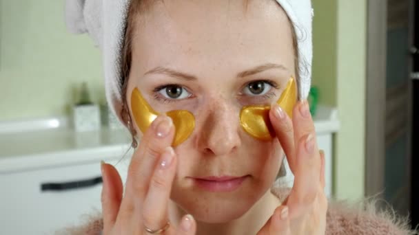 Mulher atraente spplying remendos faciais cosméticos em casa — Vídeo de Stock