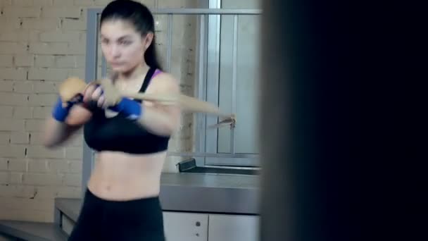 Bonito kickboxing mulher formação perfuração com elástico banda no estúdio de fitness força feroz ajuste corpo kickboxer série — Vídeo de Stock