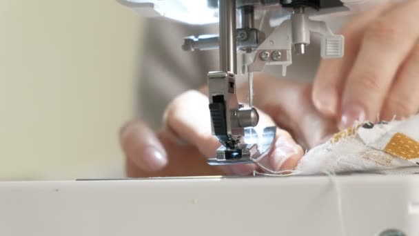 Woman seamstress sewing on a sewing machine — Stockvideo