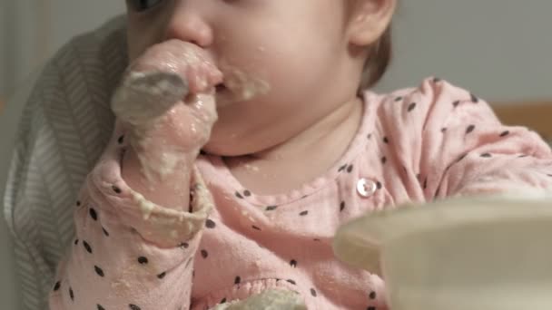 Menina pequena comendo mingau de cereal . — Vídeo de Stock