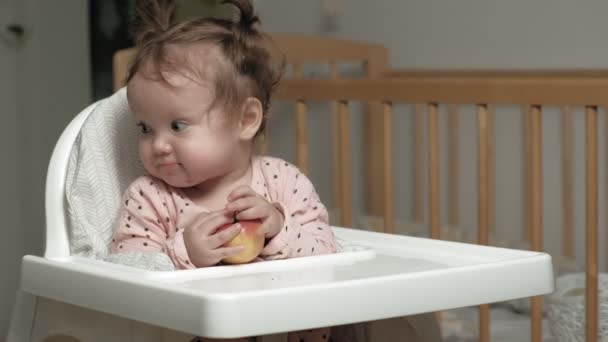Маленька дівчинка їсть яблуко . — стокове відео