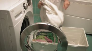 Çamaşırları yıkamadan önce yıkayan bir kadın.