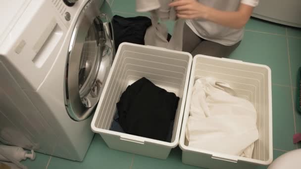 A woman sorts laundry before washing. — Stock Video