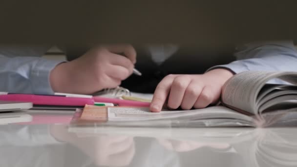 Teenage girl in a school uniform does homework — Stock Video