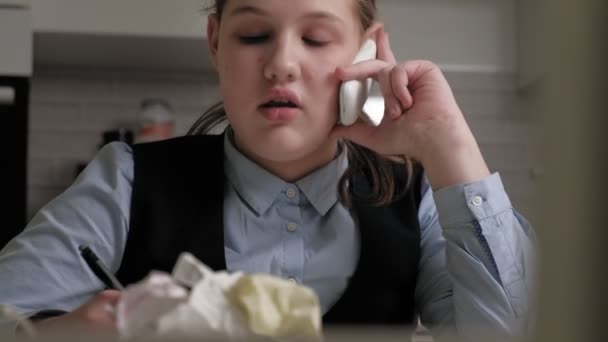 Teenage girl in a school uniform does homework — Stock Video