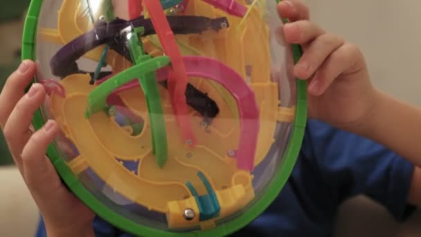 Preschooler boy plays with puzzle game — Stock Video
