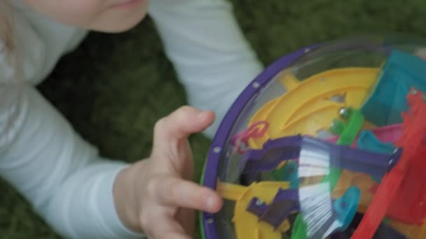 Little girl play with three-dimensional toy puzzle — Stock Video