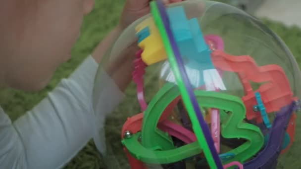 Little girl play with three-dimensional toy puzzle — Stock Video