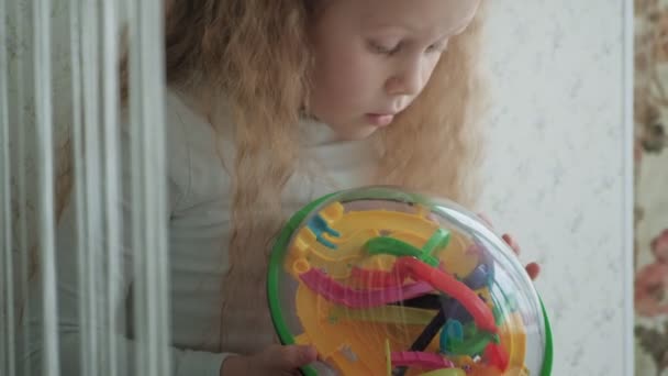 Девочка играет с трехмерной игрушечной головоломкой — стоковое видео