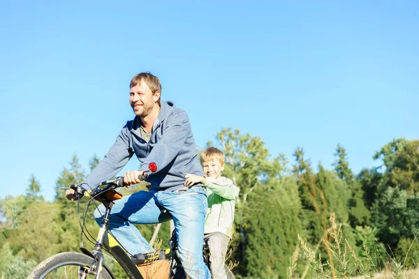 Father and son riding on the bicycle — Stock Photo, Image
