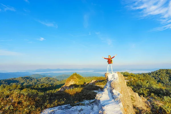 Hiker with backpack standing with raised hands on top — Stock Photo, Image