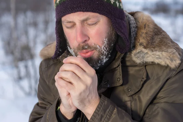 man shivering in cold winter