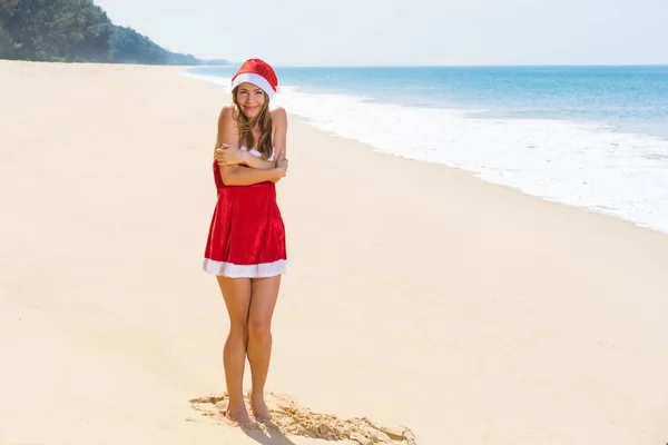 海のビーチで赤のクリスマスの服の女性 — ストック写真