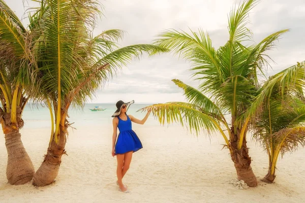 Ragazza in abito sta camminando su una spiaggia di palme tropicali — Foto Stock
