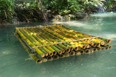 Bamboo raft in river. Selective focus. clipart