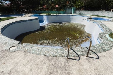 Abandoned swimming pool in resort. clipart