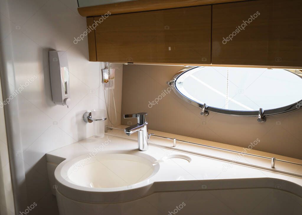 Sink and silver faucet in the luxury yacht. Selective focus.