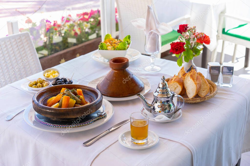 Moroccan food: tajine, mint tea, olive and bread. Focus on tajine.