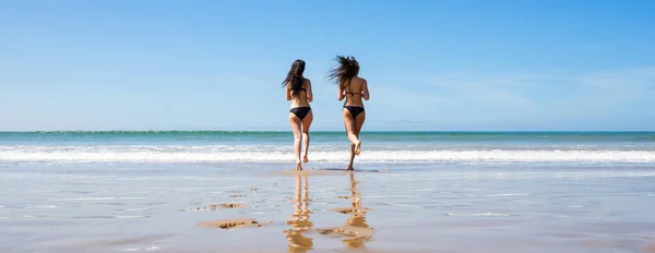 Two Young Women Swimwear Running Beach Back View Hair Motion — Foto de Stock