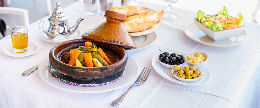 Moroccan food: tajine, olive, mint tea, salad and bread. Banner edition.