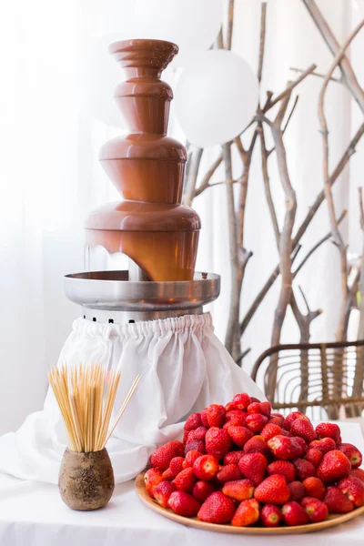 Chocolate fountain at the party. Chocolate Strawberry Fondue