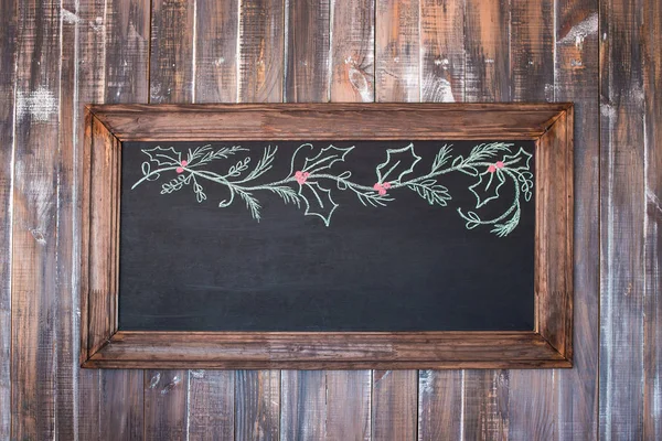 Front view of a blank blackboard over  weathered wooden surface — Stock Photo, Image