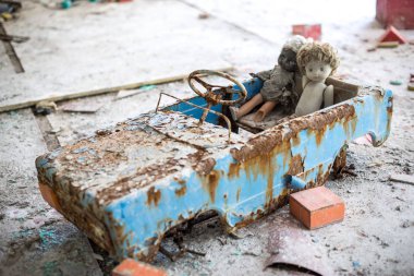 Abandoned kindergarten in Chernobyl Exclusion Zone. Lost toys, A broken doll. Atmosphere of fear and loneliness. Ukraine, ghost town Pripyat. clipart