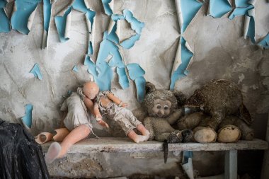 Abandoned kindergarten in Chernobyl Exclusion Zone. Lost toys, A broken doll. Atmosphere of fear and loneliness. Ukraine, ghost town Pripyat. clipart