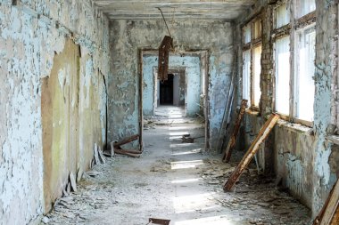 Corridor of abandoned middle school in Pripyat city in Chernobyl Exclusion Zone, Ukraine clipart