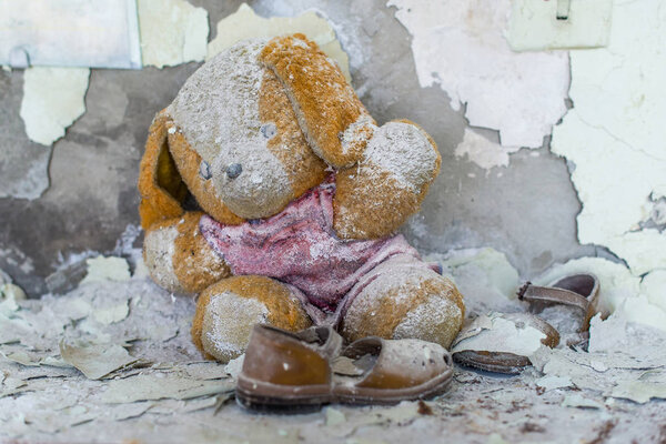 Abandoned kindergarten in Chernobyl Exclusion Zone. Lost toys, A broken doll. Atmosphere of fear and loneliness. Ukraine, ghost town Pripyat.