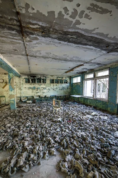 Máscaras de gas en el suelo en la escuela secundaria en Pripyat, zona de exclusión de Chernobyl. Catástrofe nuclear — Foto de Stock