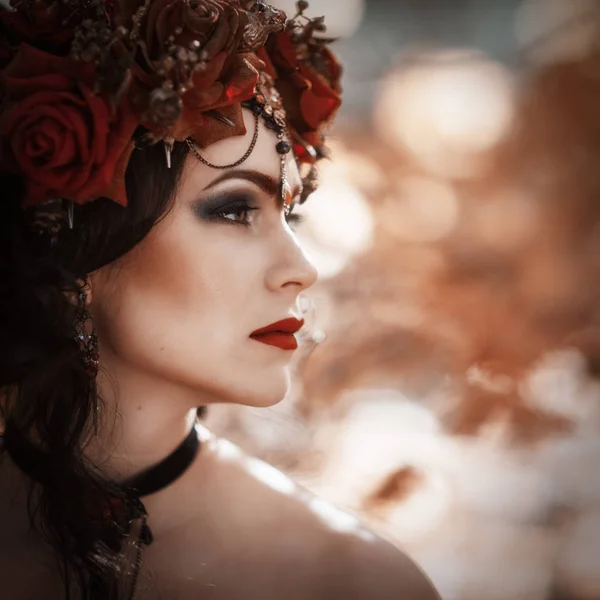 Portrait of a woman in a red dress and wreath — Stock Photo, Image