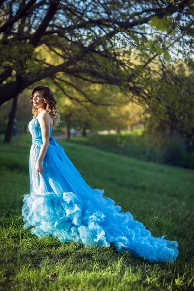 Jovem menina bonita em um vestido azul exuberante — Fotografia de Stock