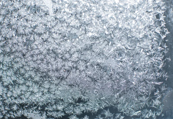 Frosty patterns on glass in winter — Stock Photo, Image