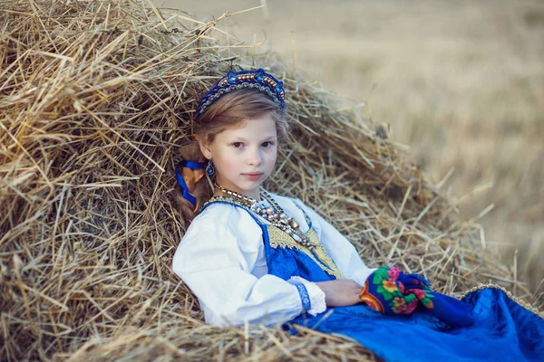 Little girl in Russian costume in the field — Stock Photo, Image
